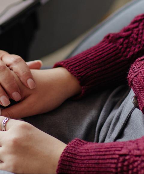 Close up of two people holding hands