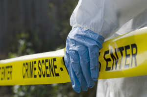 Crime scene tape and biohazard protective glove.