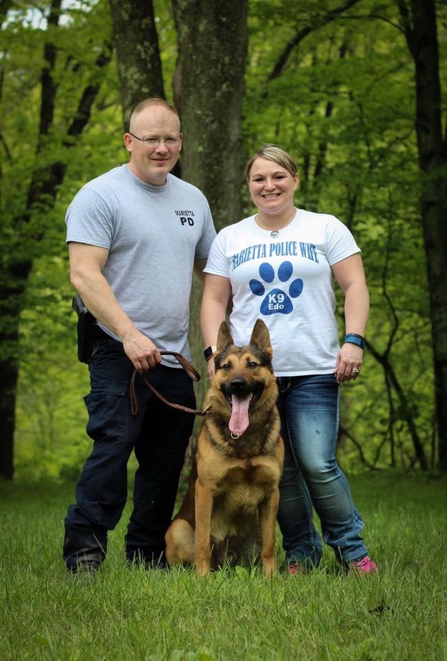 K9 Edo from Marietta Police Department with handlers posing in woods.