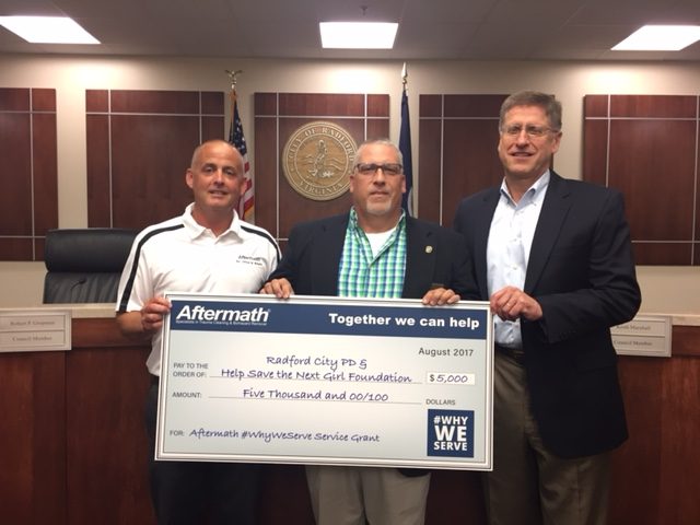 Aftermath presents check to Radford City PD.