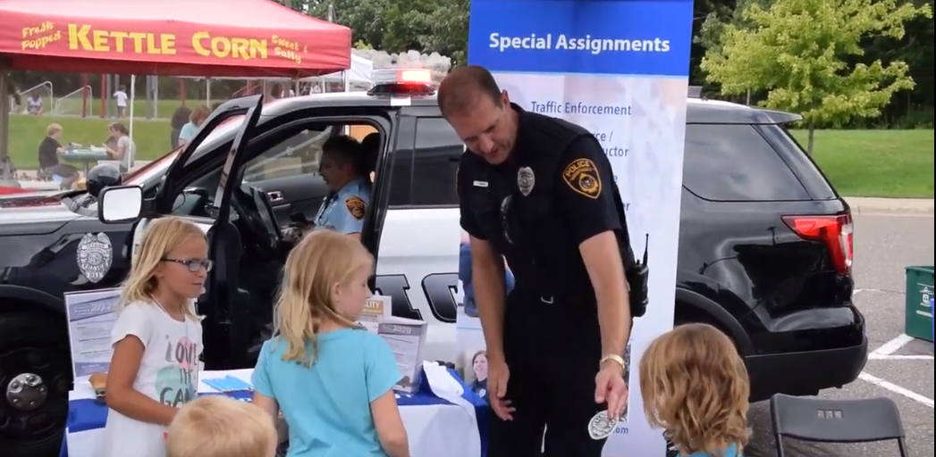 officer gives sticker to little girl